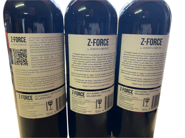 Three Z-Force wine bottles with labels on a wooden surface.