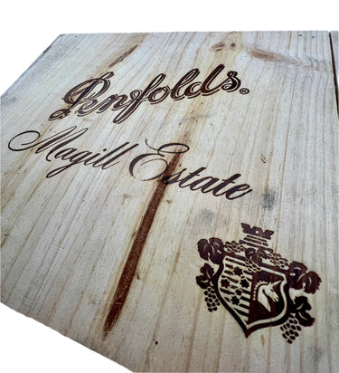 Wooden surface with 'Penfolds Magill Estate' branding and logo.