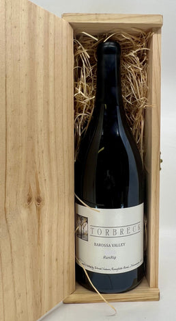 Wine bottle in a wooden box with straw lining