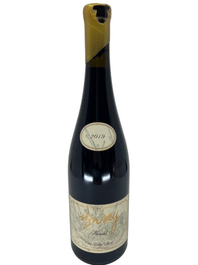 Wine bottle with a label on a light gray background