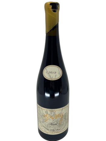 Wine bottle with a label on a light gray background