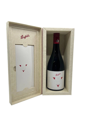 Wine bottle in a wooden box with a card on a white surface